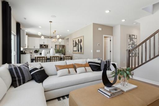 Open floorplan creates a seamless connection between the family room, kitchen, and dining areasâideal for entertaining and family togetherness..jpg