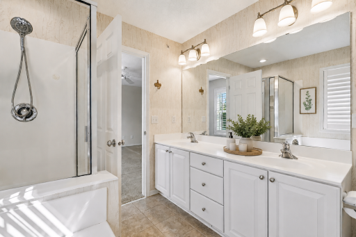 Primary suite with jetted tub and walk-in shower.