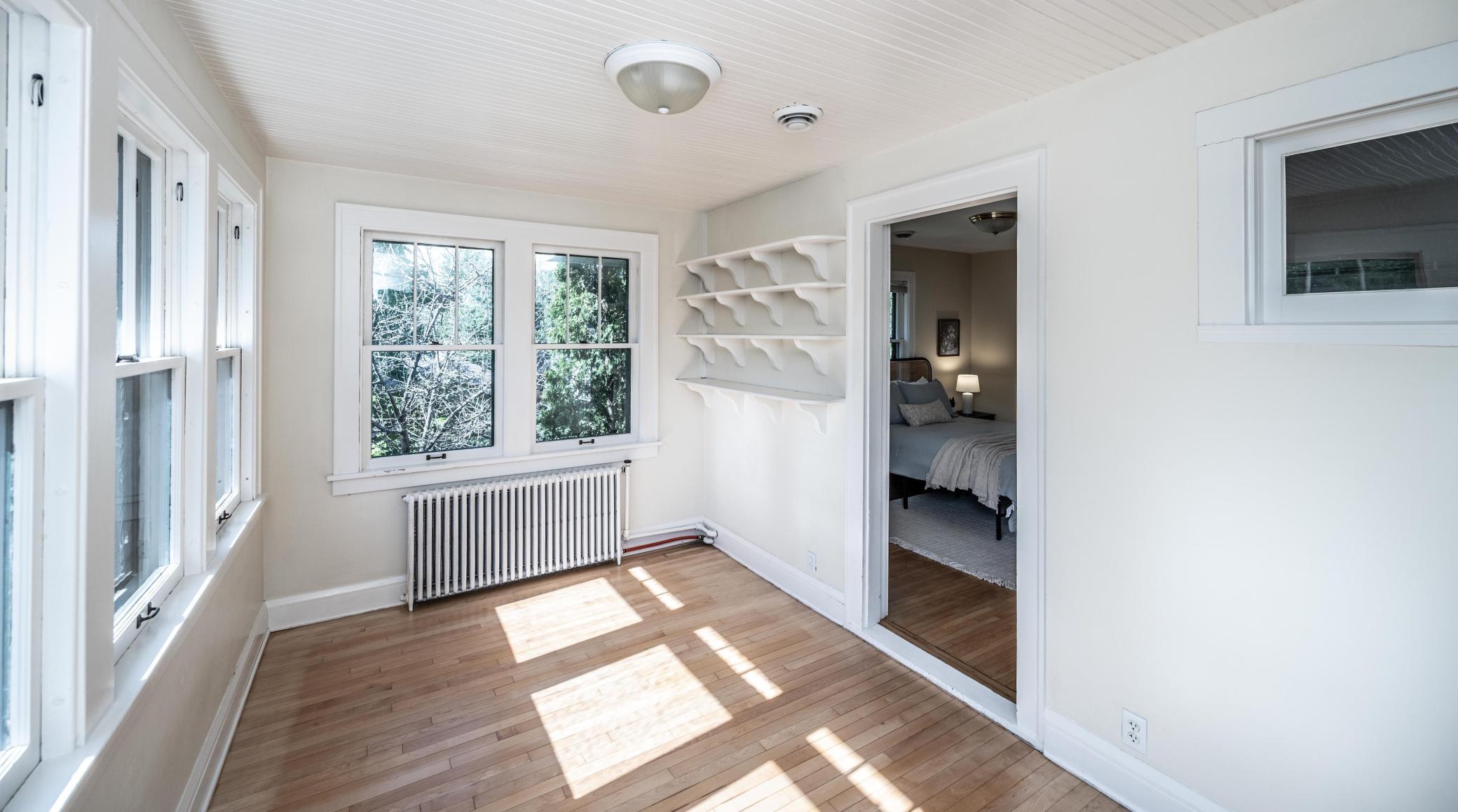 The primary bedroom is enlarged by a private sunroom