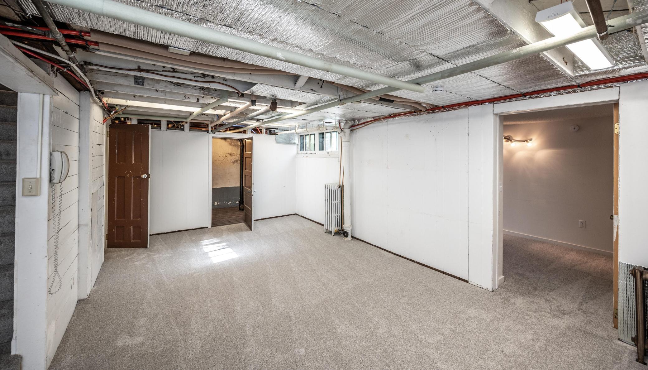 Lower level features a rec room, bedroom, full bath, utility, laundry, and storage