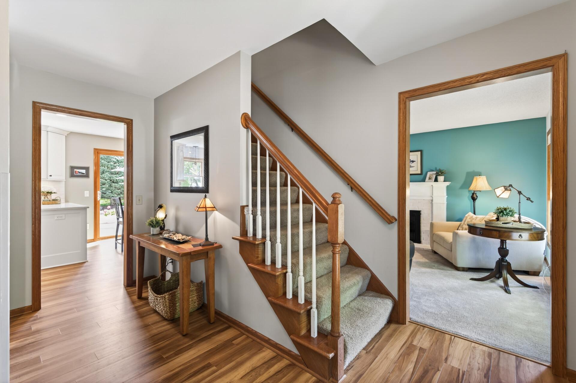 Step inside to this bright and inviting foyer with warm woodwork, durable flooring, and views into multiple living spaces