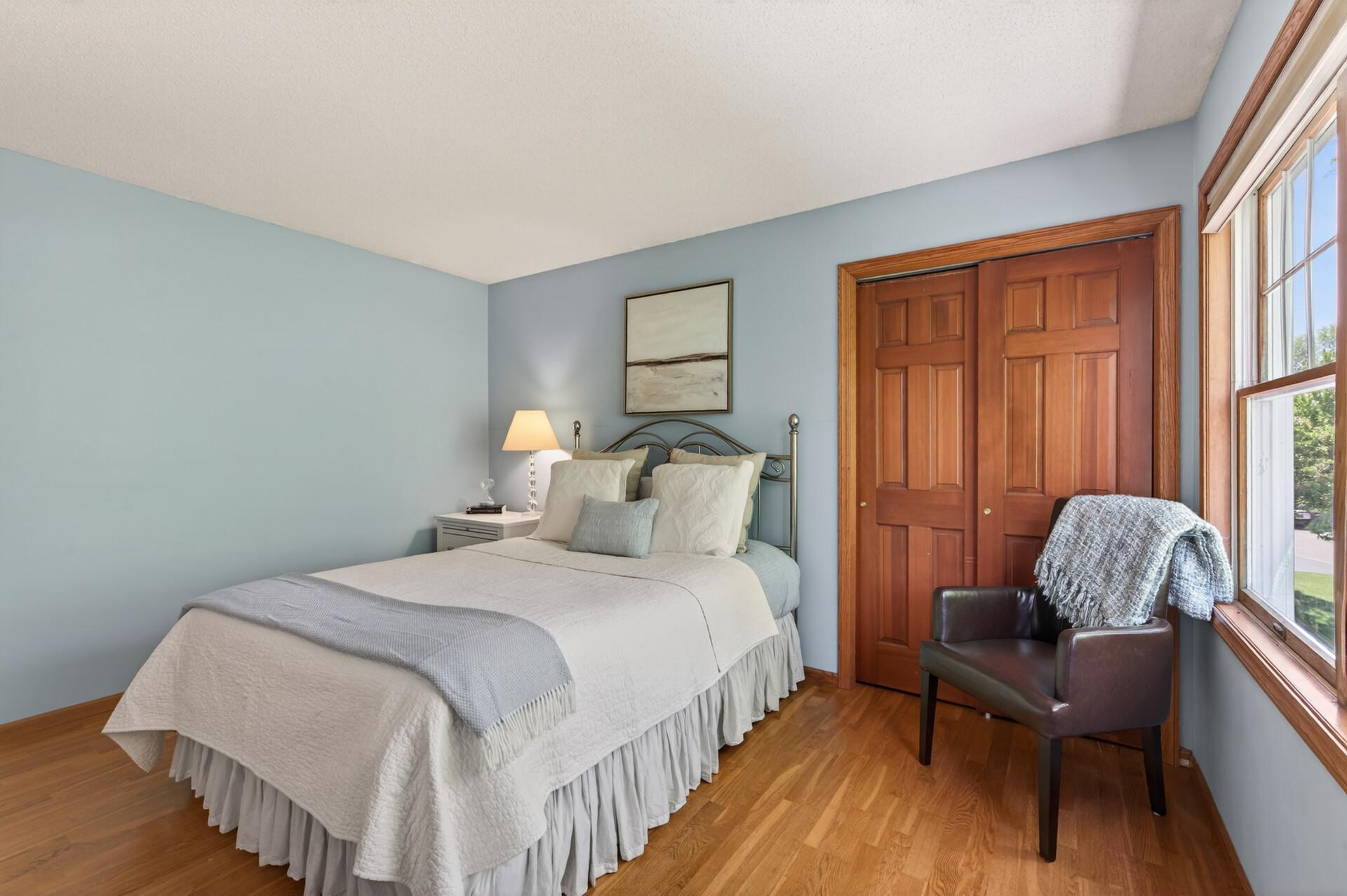 This bedroom supports a full size bed, nightstand, dresser, accent chair and reach-in closet.