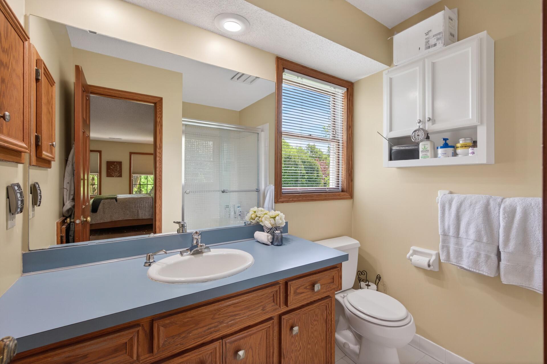 Private primary 3/4 bath includes large vanity with plenty of storage, medicine cabinet for storage and shower