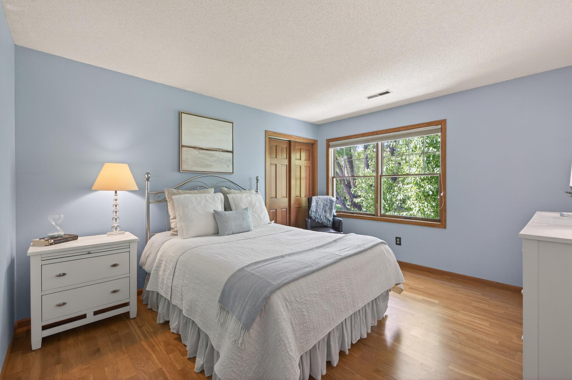 This second bedroom on the upper level is a place of piece and tranquility with calming paint, plenty of space to relax and beautiful hardwood floors.