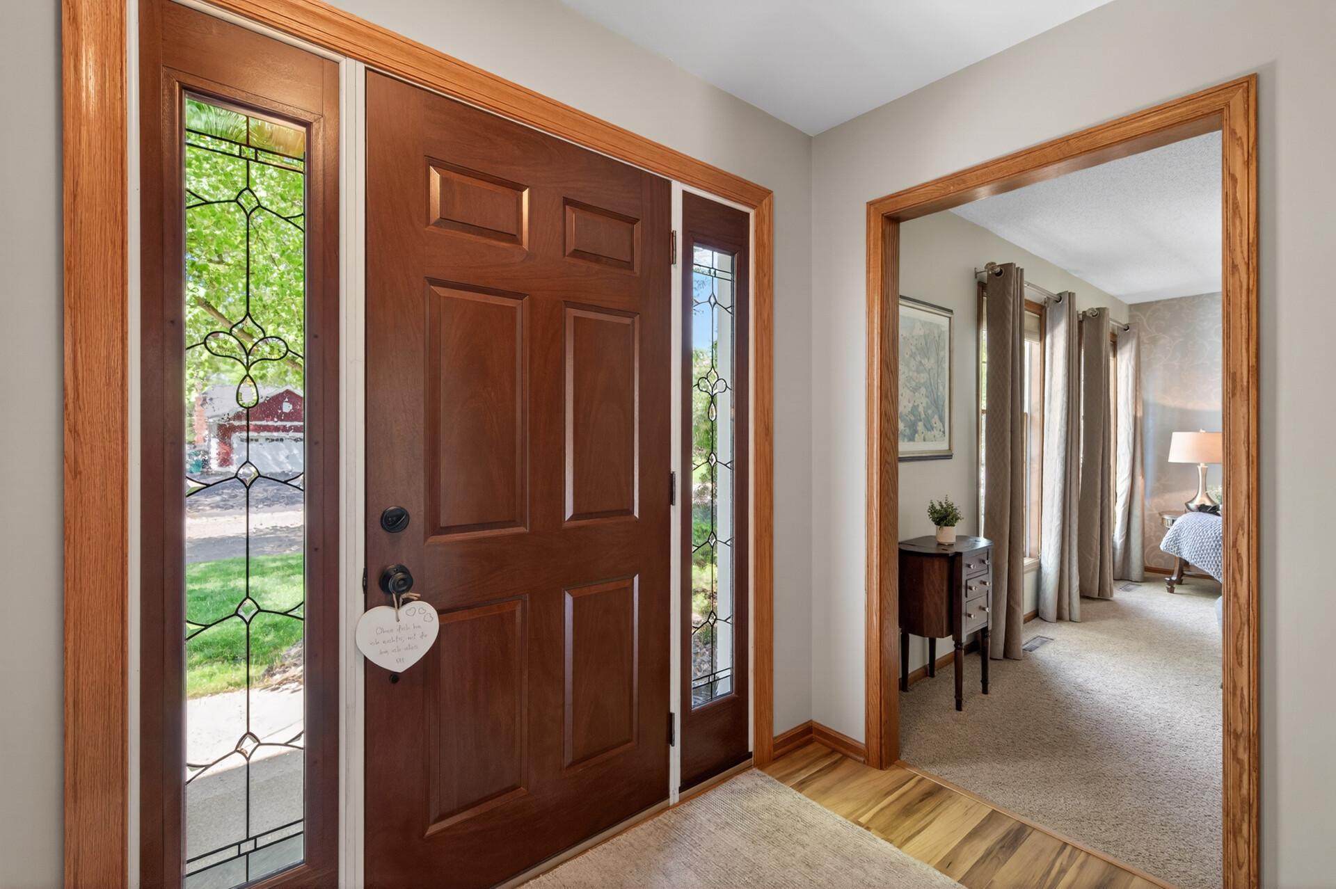 Elegant grand entrance with beautiful sidelight and full view storm door always an abundance of nature light