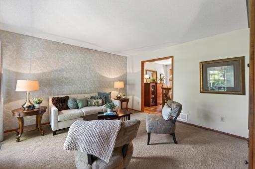 Well appointed front living room with large windows adjoins the formal dining room.