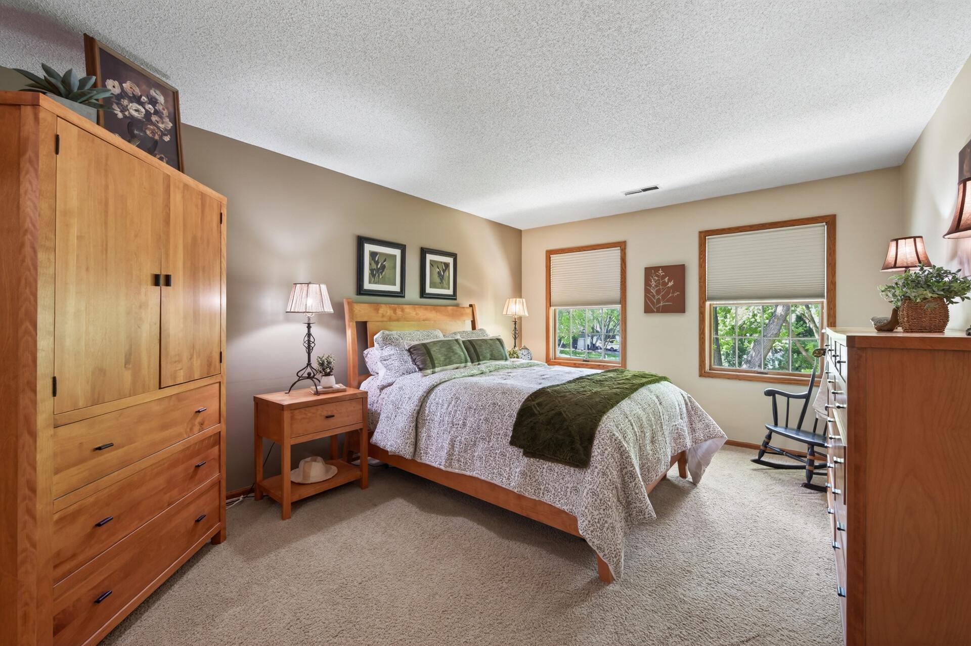 This upper level primary suite is huge to allow for plenty of furniture configurations and bright views to the frontyard.