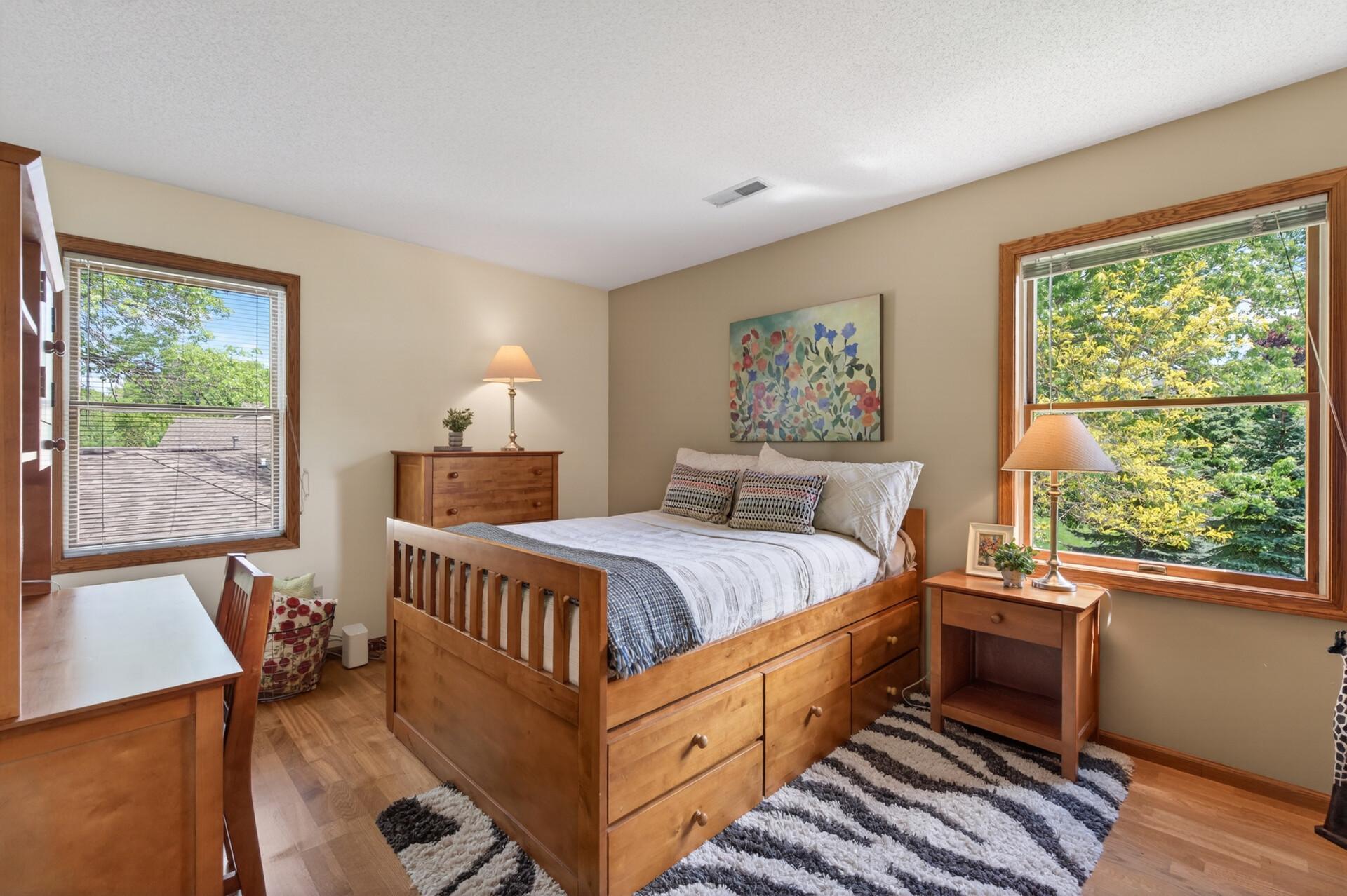 One of 3 additional bedrooms, this one has both views of the back and side yard. Yes, those are hardwood floors