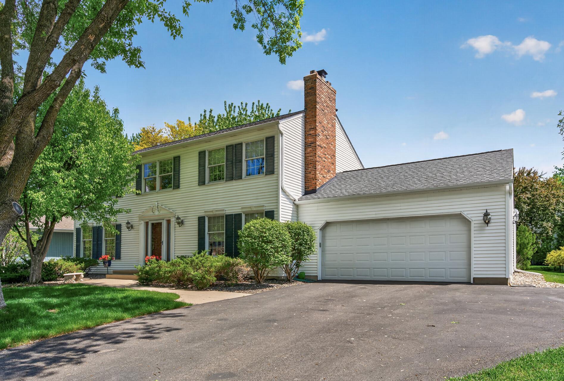 Spacious asphalt driveway and attached 2 car garage