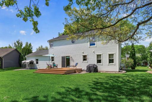 Spacious backyard retreat featuring a large deck, mature shade trees, and exceptional privacy.