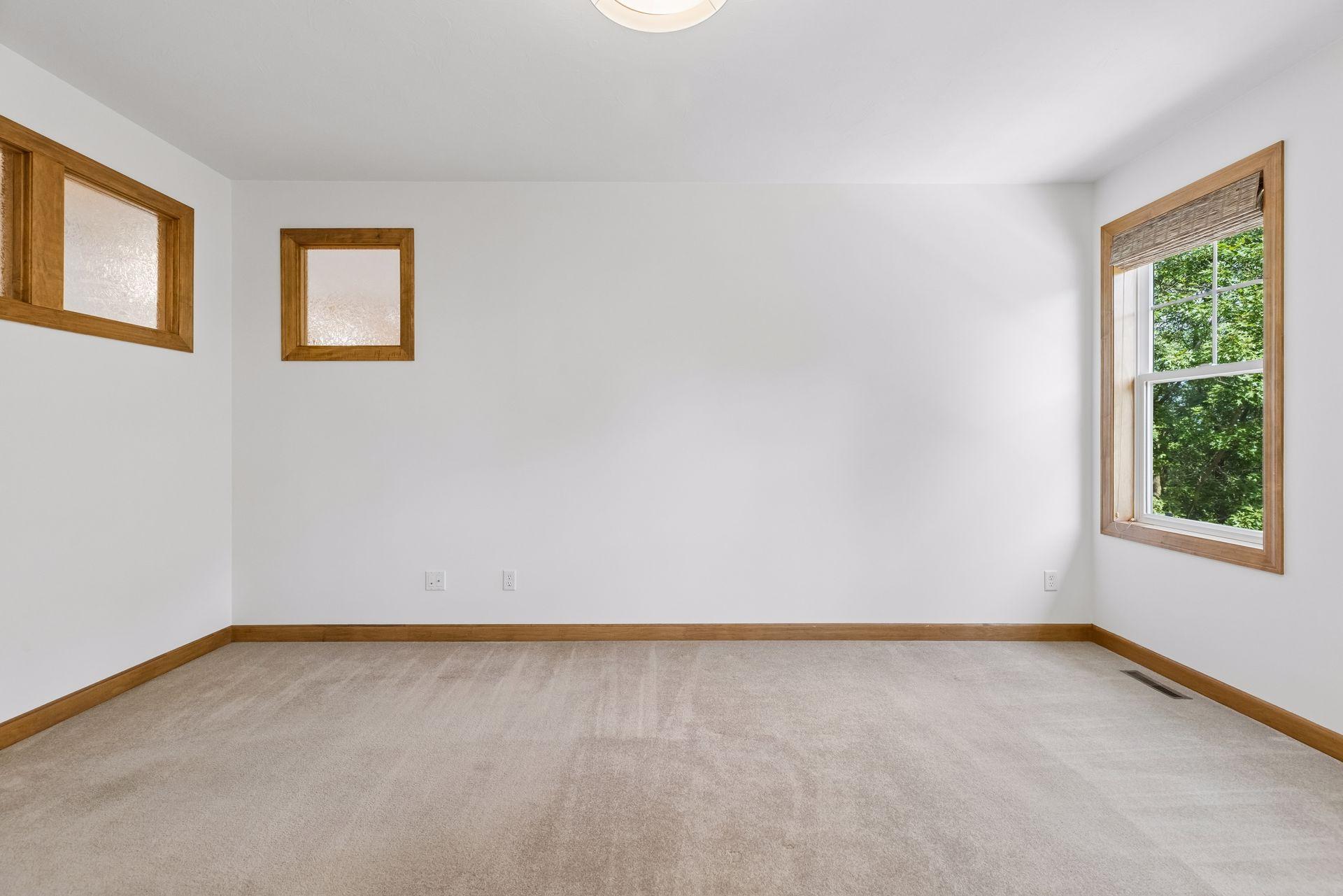 Primary bedroom with thoughtfully placed frosted glass windows to provide more natural light in the home.