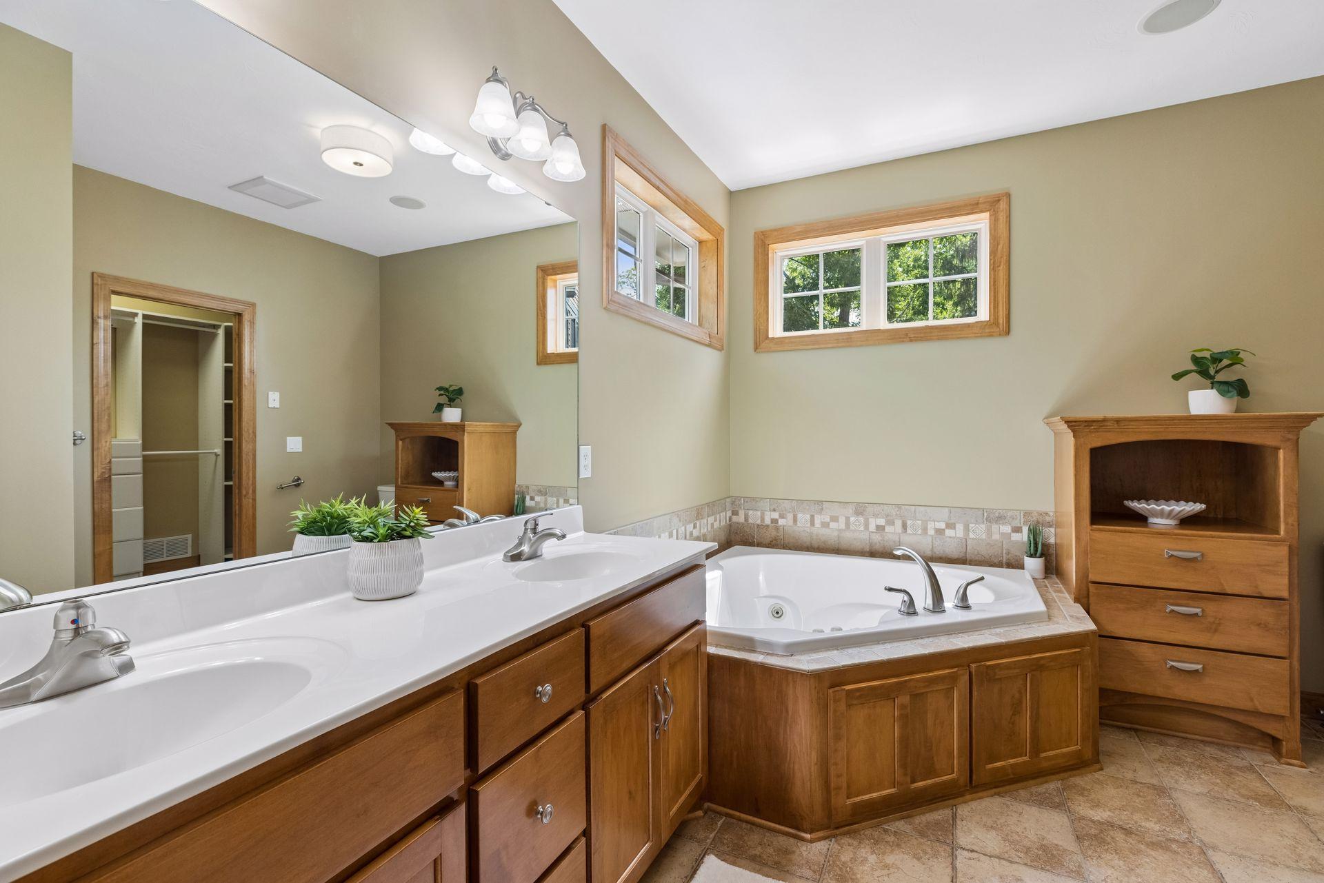 Primary bathroom with dual sinks, separate tub and shower, additional storage. New vanity top to be installed 6/26.
