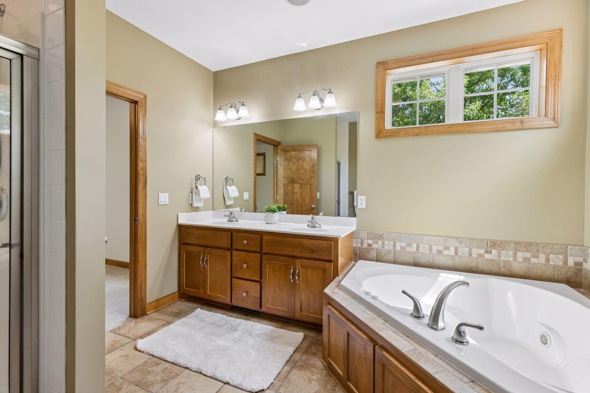 Spacious primary bathroom will have a new quartz countertop installed soon. Built-in speakers.