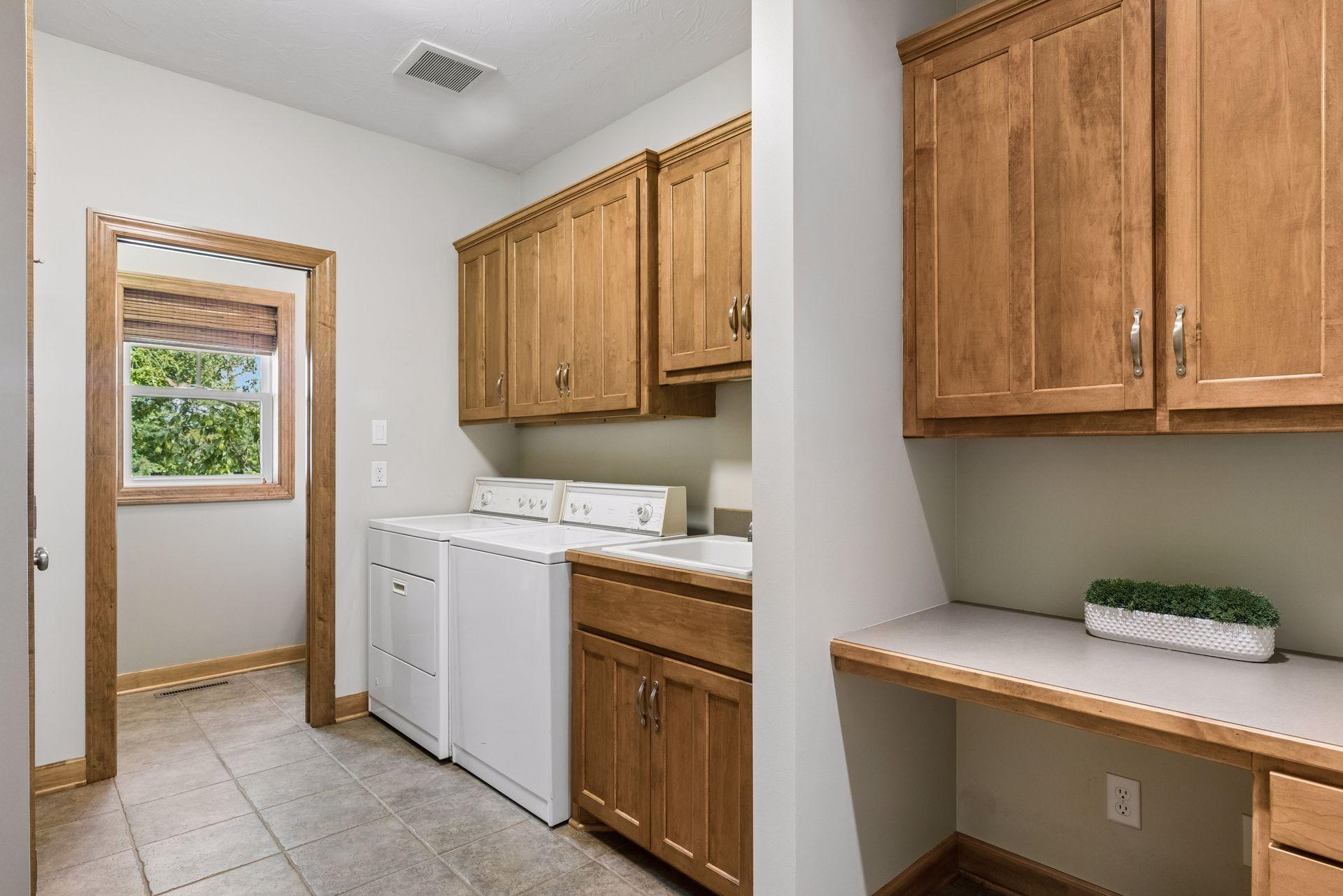 Main floor mudroom and laundry with tons of cabinetry, closet for storage and a command center area.