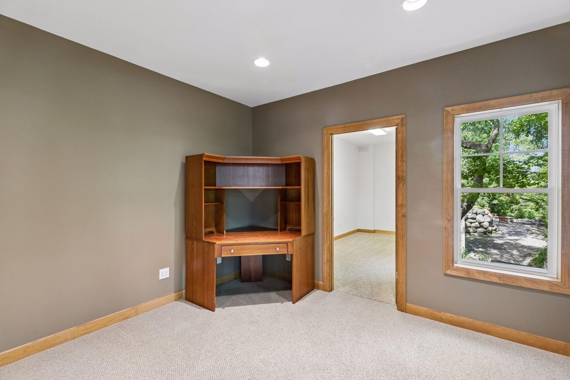 Lower level office with french doors. Additional room to the right.