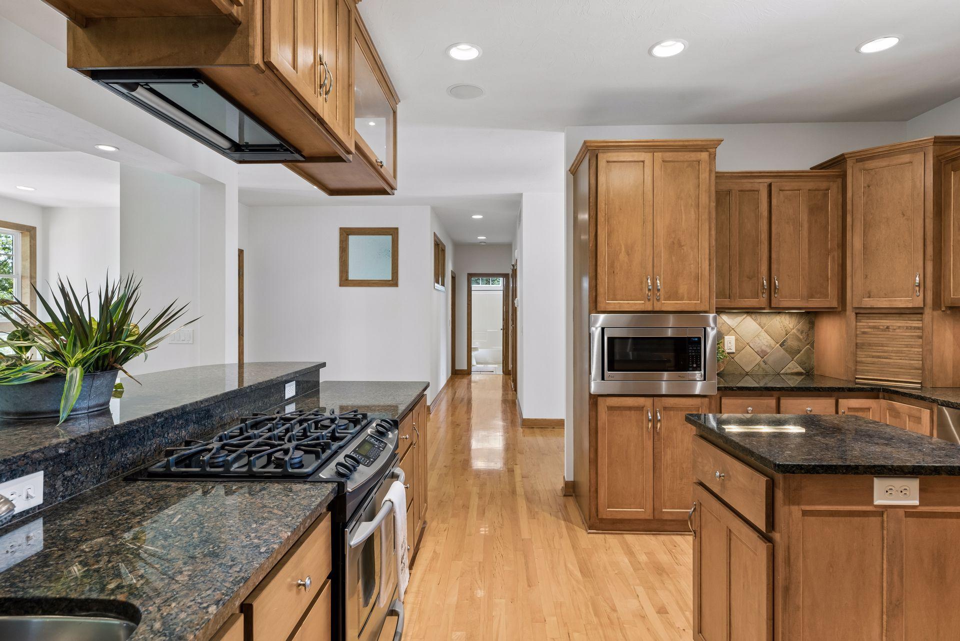 Gas cooktop, second prep sink and so many thoughtful features were put into this home. Built-in spice racks above the microwave in cabinet.