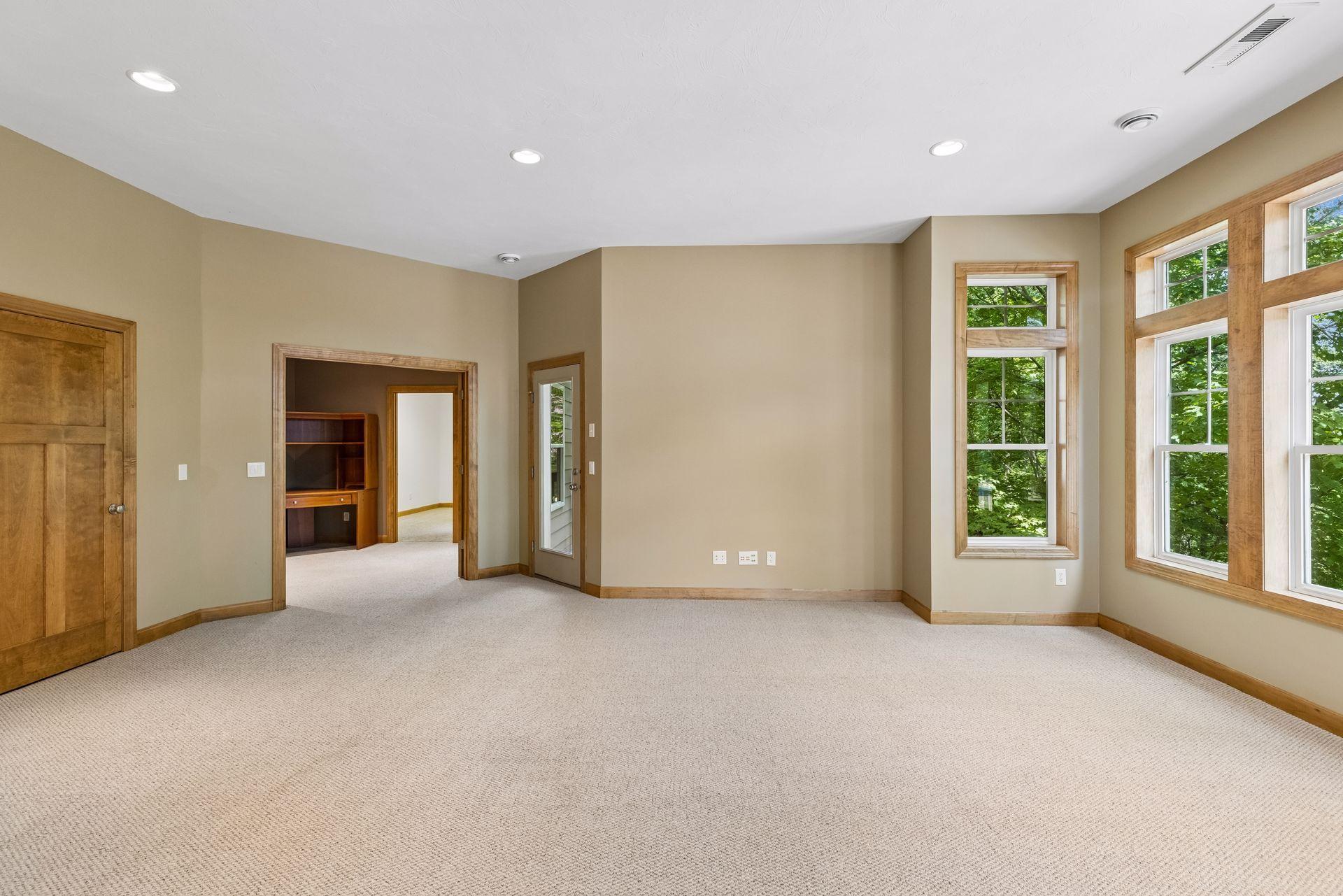 Lower level family room with 10 foot ceilings. Door to the left leads down to the third level.