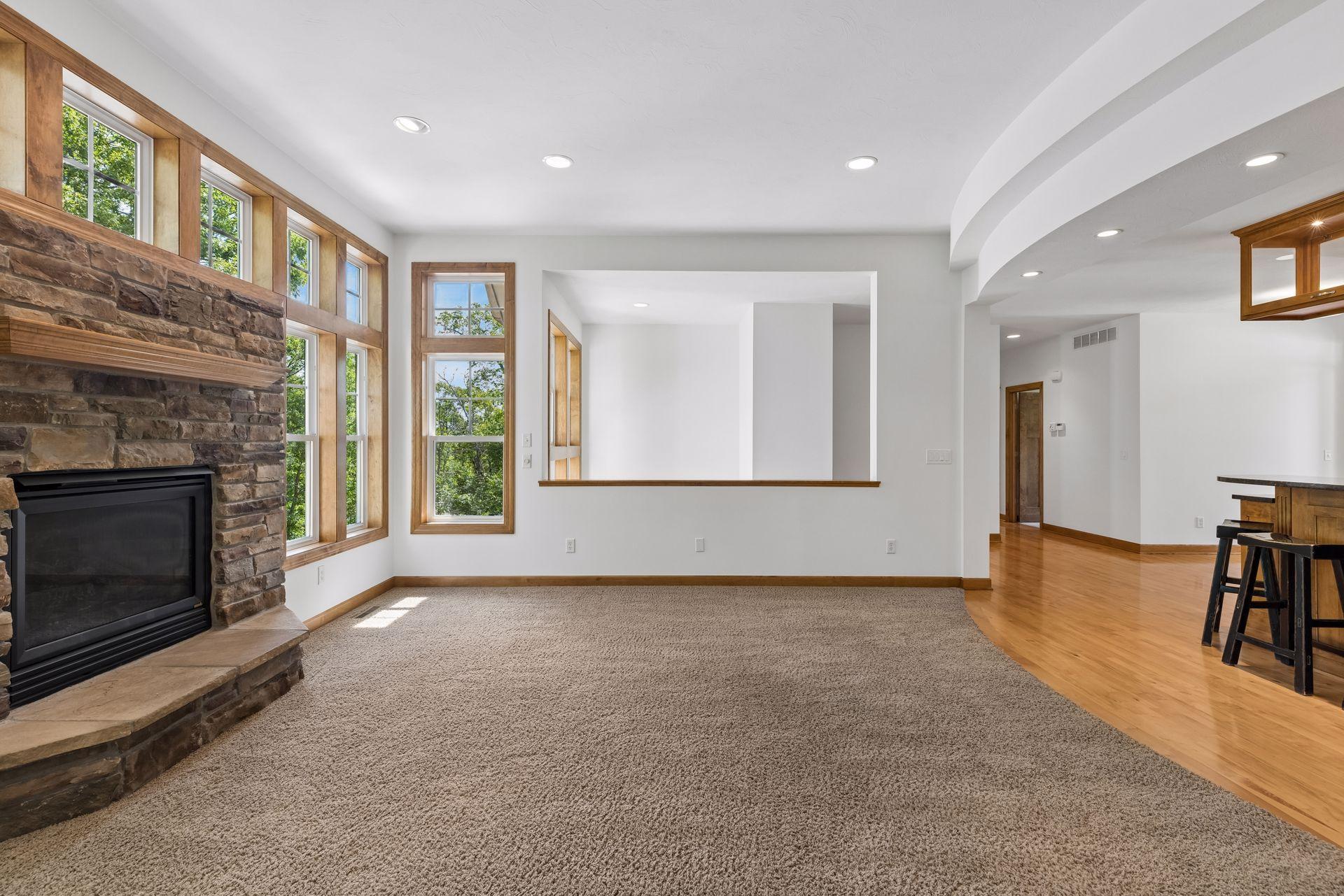 Gas fireplace with stone surround. Open to the stairway. lots of recessed lighting.