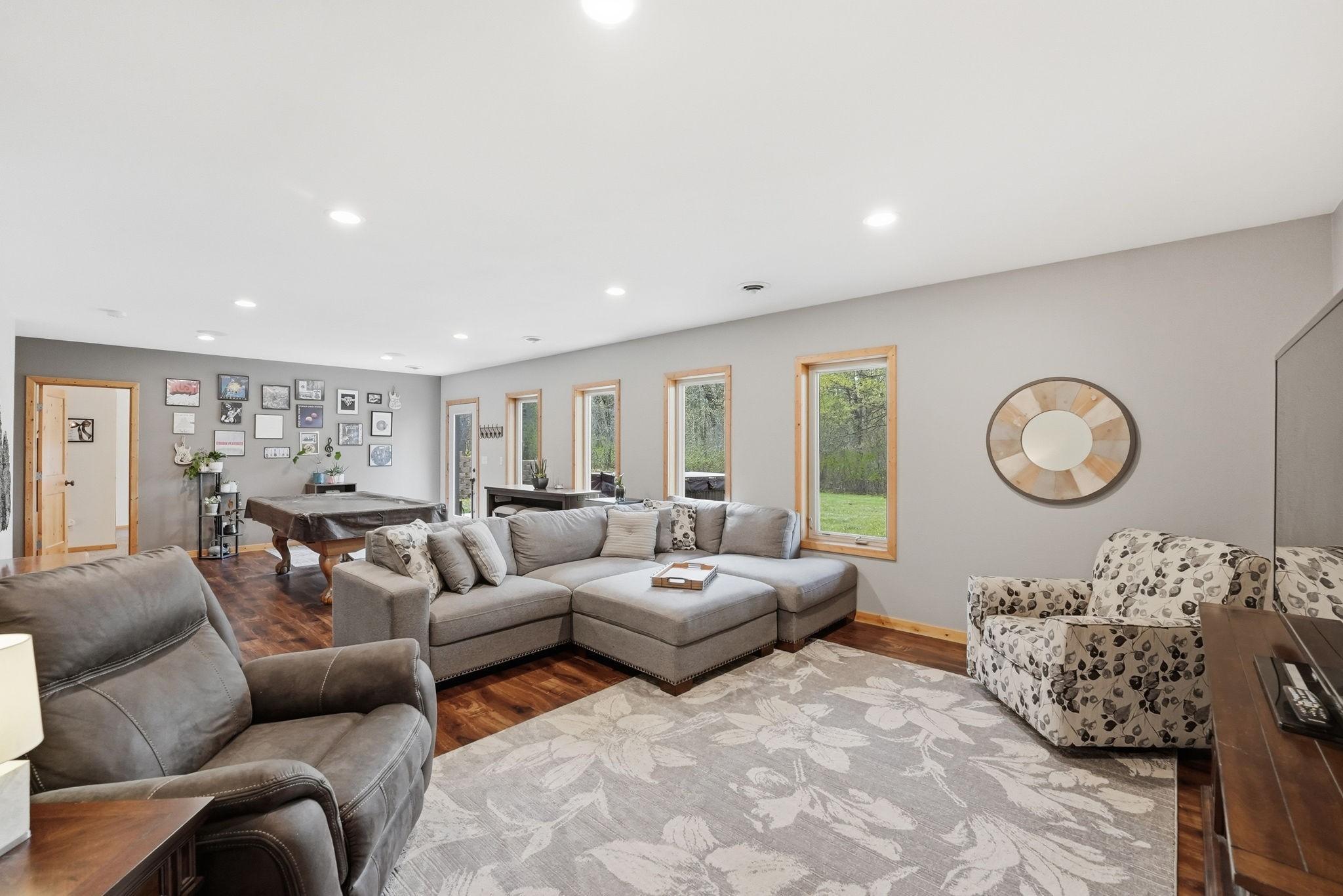 Spacious lower level family room with new updated flooring! Walk out to backyard patio area with hot tub.