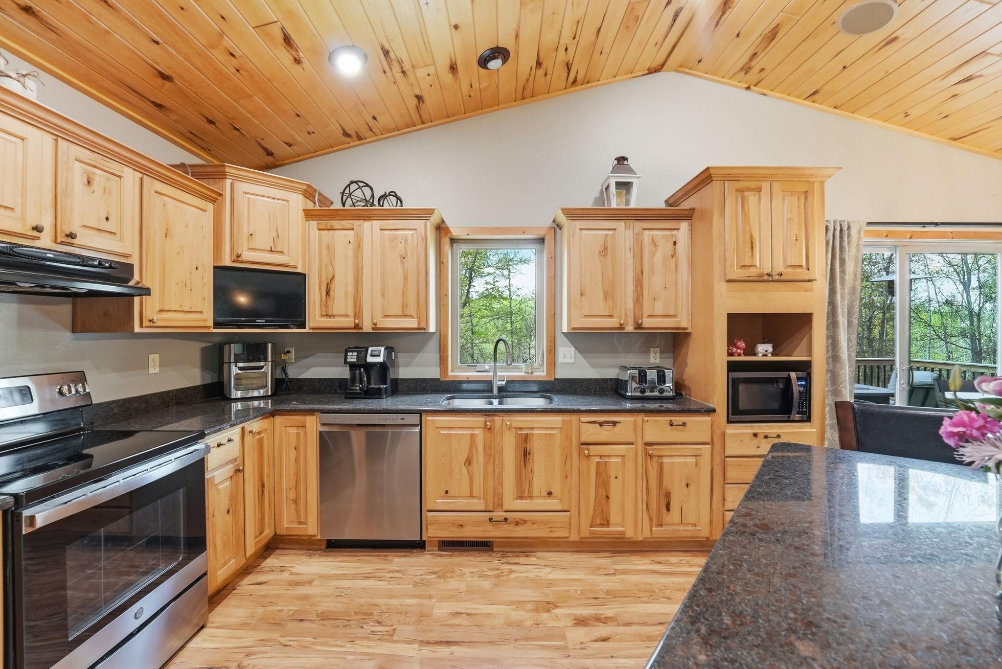 Beautiful kitchen complete with large center island, abundant alder cabinetry and newer stainless steel appliances