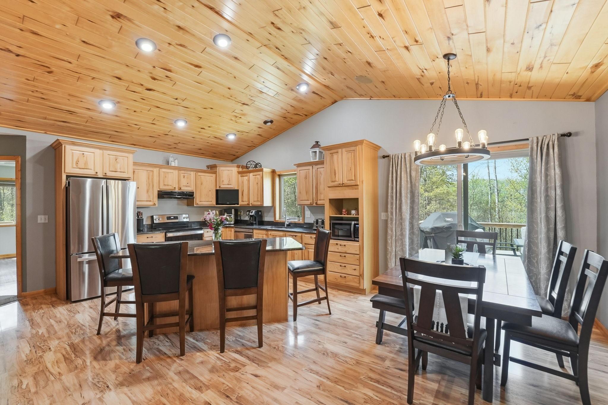 Large kitchen-dining-living room area with walk out to deck/backyard