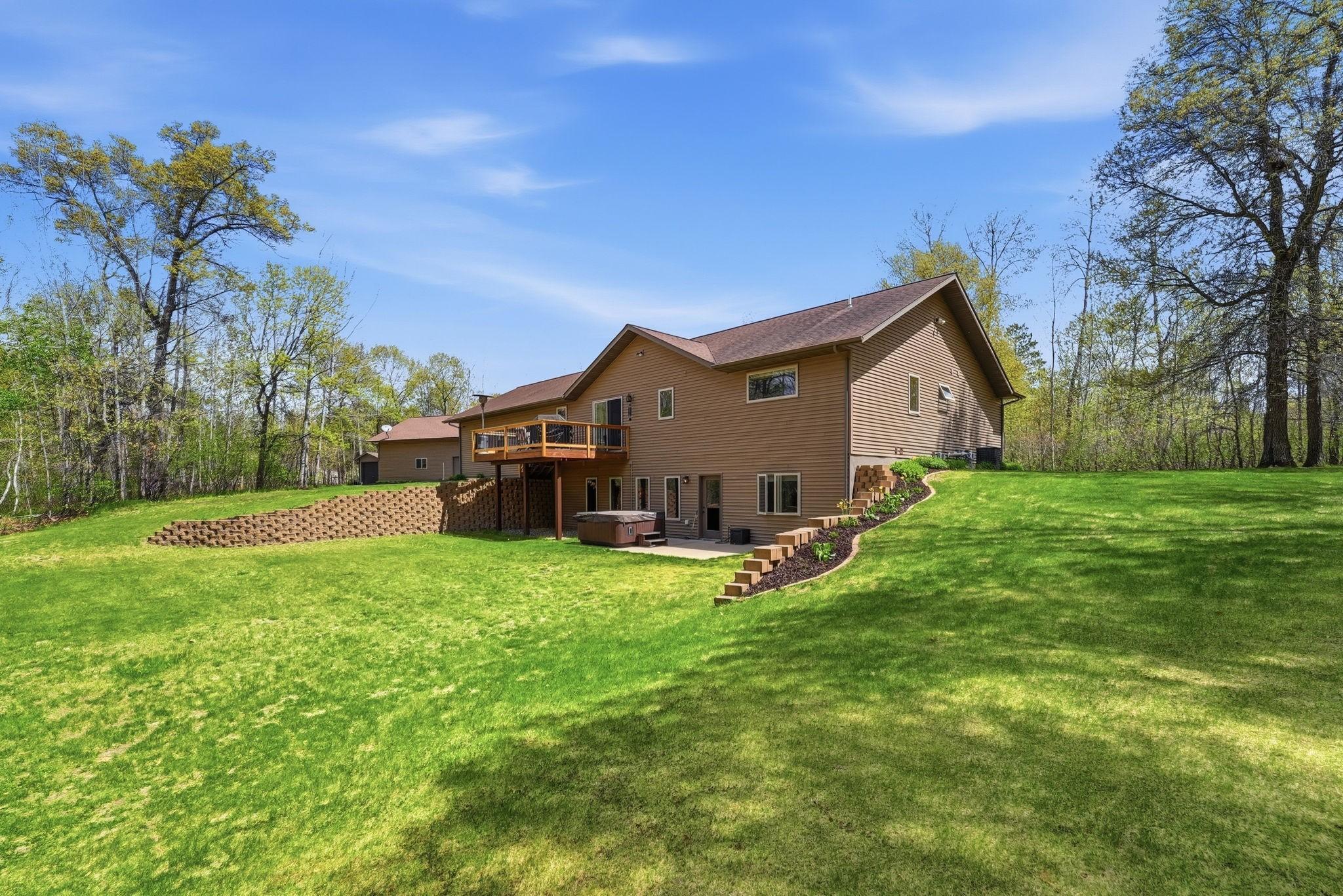 Beautiful private backyard! Lots of yard space, woods, backyard patio with hot tub. Beautiful landscape