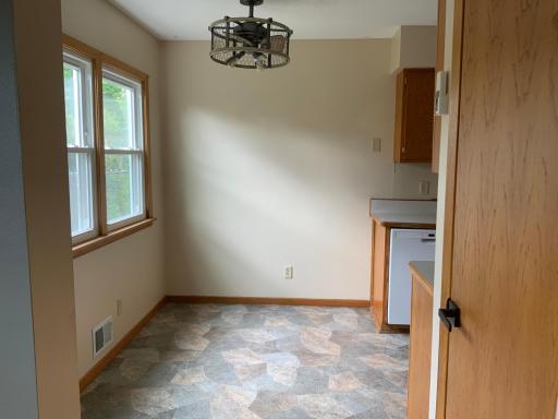 Eat in Kitchen with great lighting. Unique fixture has ceiling fan included. light
