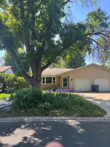Great curb appearance with perineal gardens, full shade tree, and cement driveway.l
