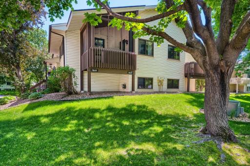 The screened porch overlooks the surprisingly large lot for a townhome setting.