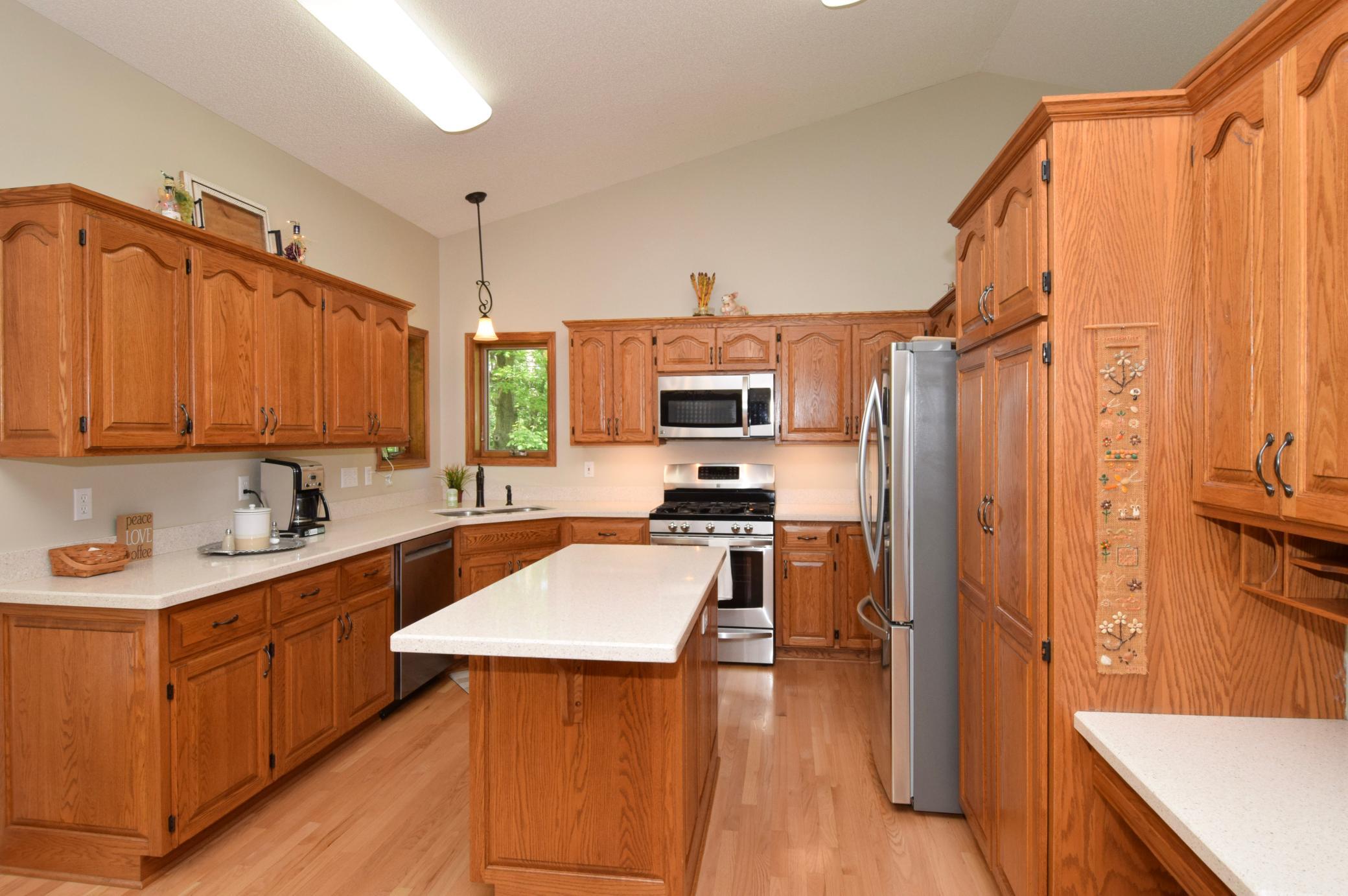 Custom Cabinetry Flanked by Solid Pristine Surface Tops! Newer Stainless Steel Appliances! Do Not Miss the Convenient Bill Pay and Homework(?) Desk!!!