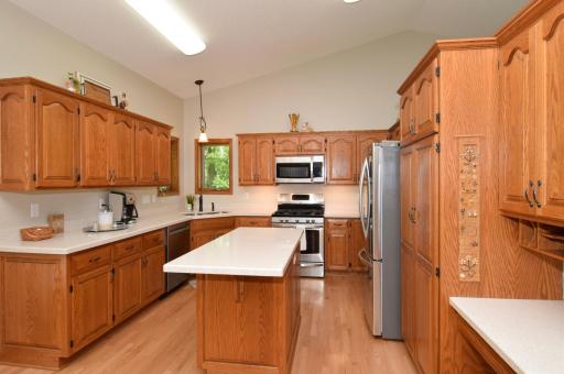 Custom Cabinetry Flanked by Solid Pristine Surface Tops! Newer Stainless Steel Appliances! Do Not Miss the Convenient Bill Pay and Homework(?) Desk!!!