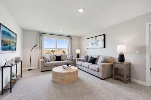 Greeting you at the top of stairs is an oversized loft space which is a great place for those informal or end of the day relaxation time. Photo of model home, colors and finishes may vary.