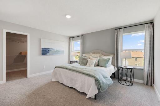 Primary bedroom provides a quiet oasis to escape from the go, go, go of everyday life. Photo of model home, colors and finishes may vary.