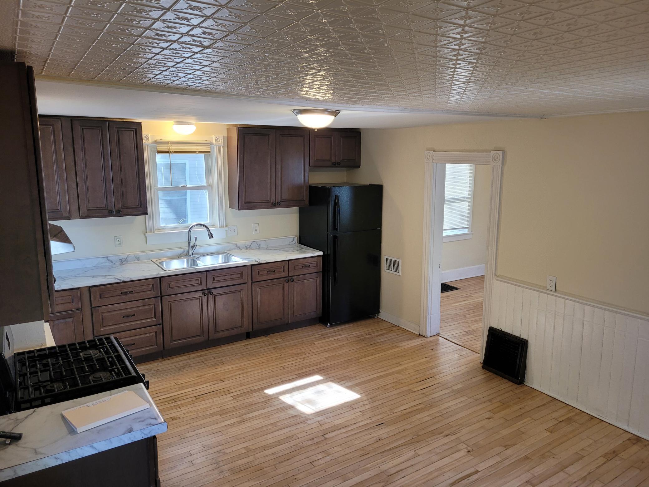 Country kitchen with tin ceiling and hardwood floors!