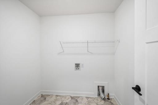 There is plenty of space on the second-floor laundry room for a new washer and dryer. Shown here with an optional rinse sink.