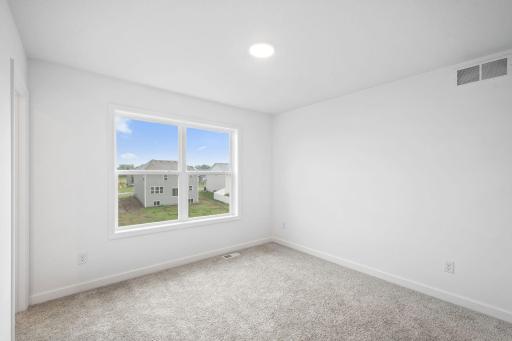 Three secondary bedrooms are located on the second floor.