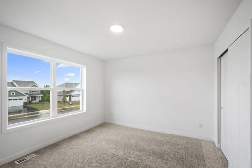 This secondary bedroom features an en-suite bathroom, making it a great space for overnight guests or household members that need more privacy.