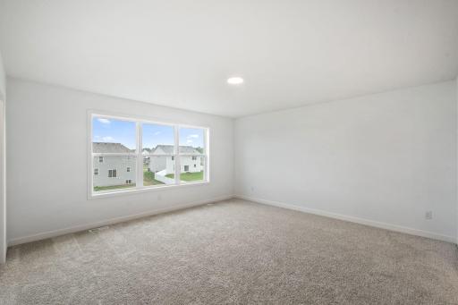 The expansive owner’s suite is located on the second level, complete with a restful bedroom, an en-suite bathroom and two walk-in closets.