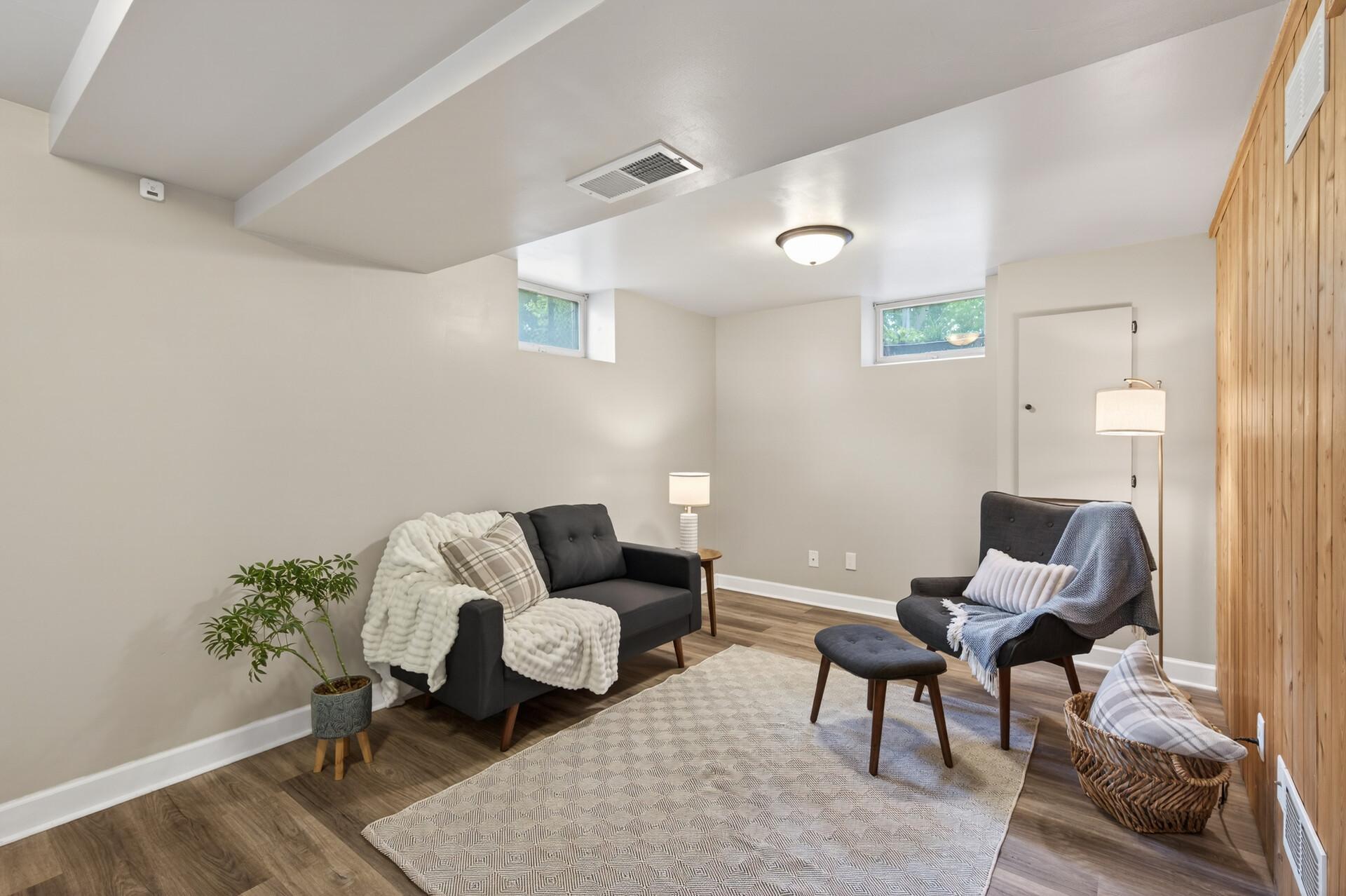 The cozy family room in the basement is the perfect spot to watch a movie and spend time with loved ones.