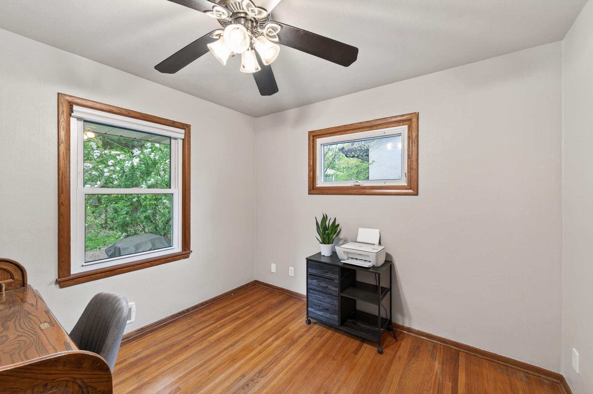 The third bedroom on the main level overlooks the serene backyard.