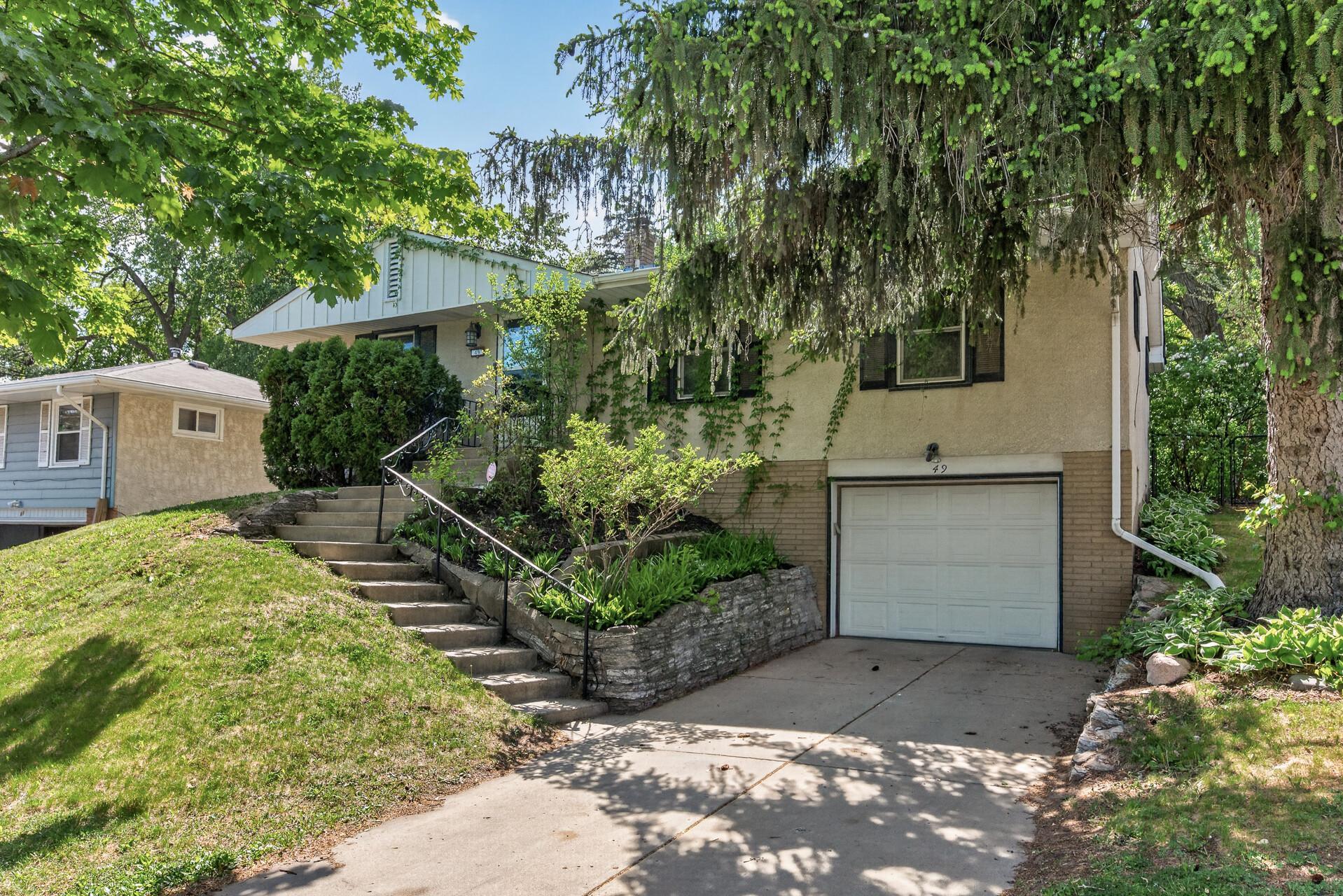 The exterior features mature landscaping and charming shutters