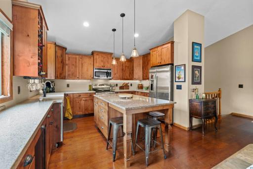 Extensively updated Kitchen. 1/2 walls removed making it larger. Added Full height alderwood cabinets and drawers. Huge 6-1/2X3-1/2 foot quartz island used for dining too. This is the favorite room for entertaining. Lots of space for appetizers, etc.