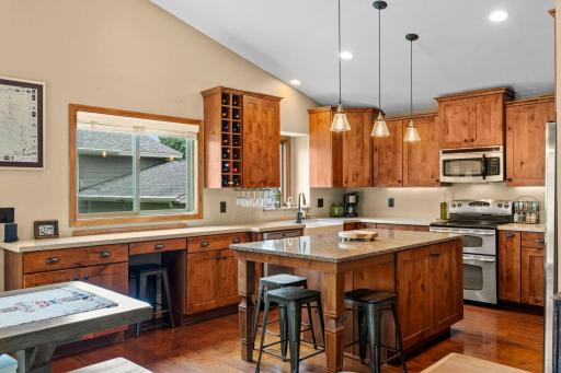Entire Kitchen has long quartz countertops. Even kitchen sink window has a quartz window sill! Note the wine rack, more entertaining.