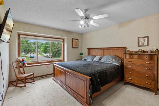 Owners Bedroom has wide picture window and ceiling fan and Deep Walk-in closet
