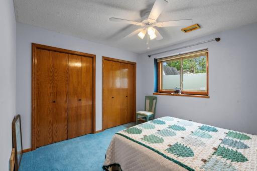 Bedroom 4 with full wall length bifold closet and ceiling fan