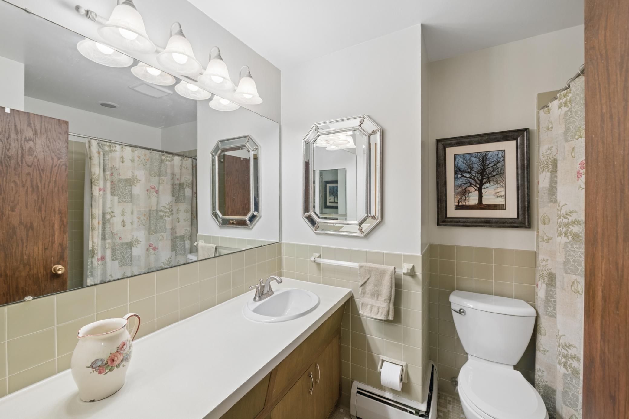 Upper-level full bath with retro tile & cabinetry