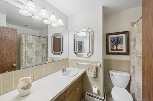 Upper-level full bath with retro tile & cabinetry