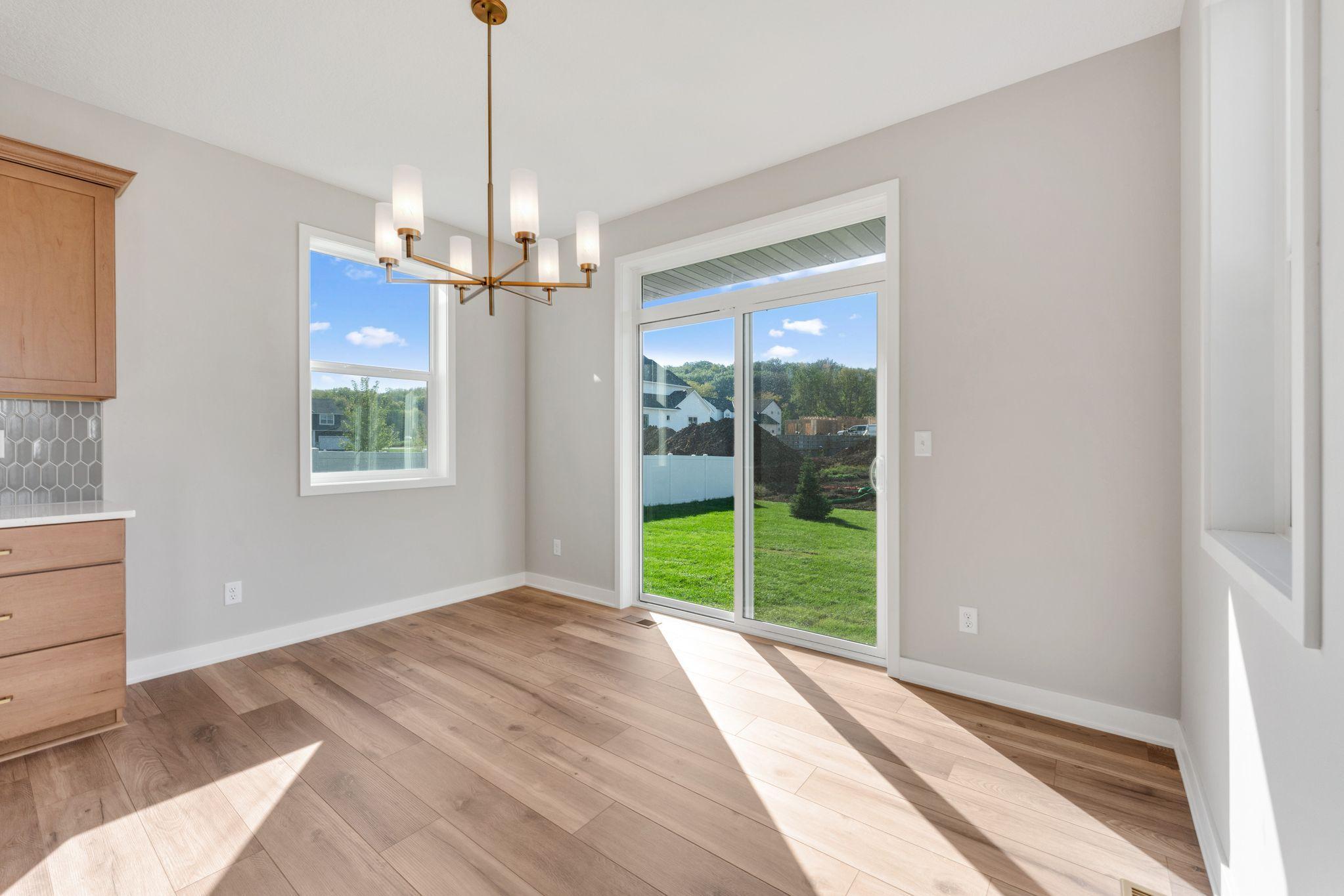 Sunny dining room with gold light fixture