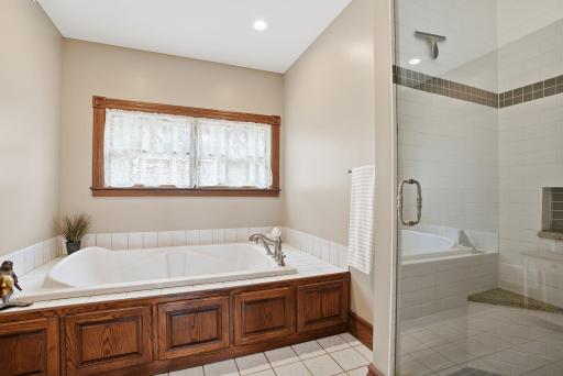 Primary bath includes massive jetted tub and tiled shower.