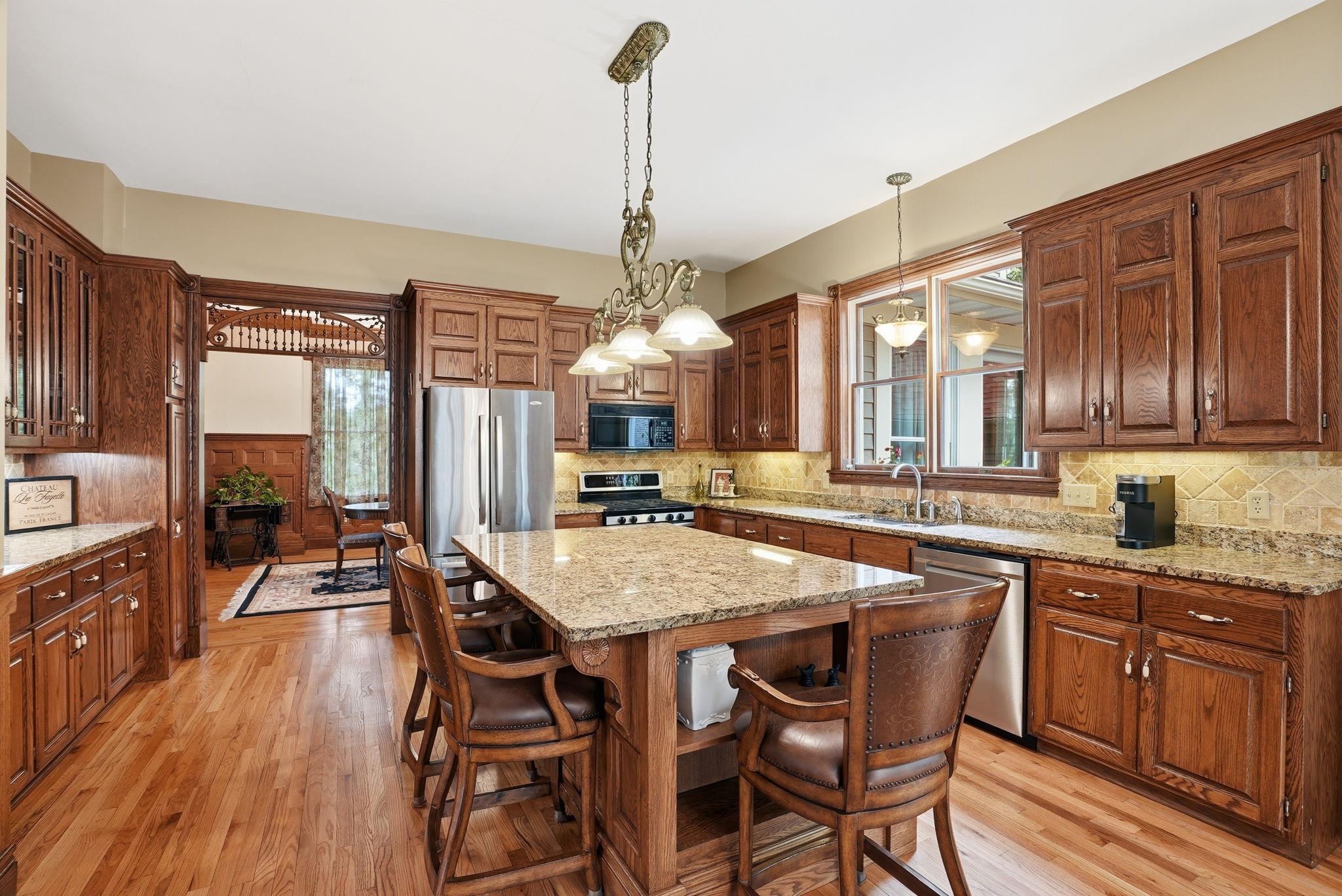 State-of-the-art kitchen boasts oversized granite island. Pull up a stool!